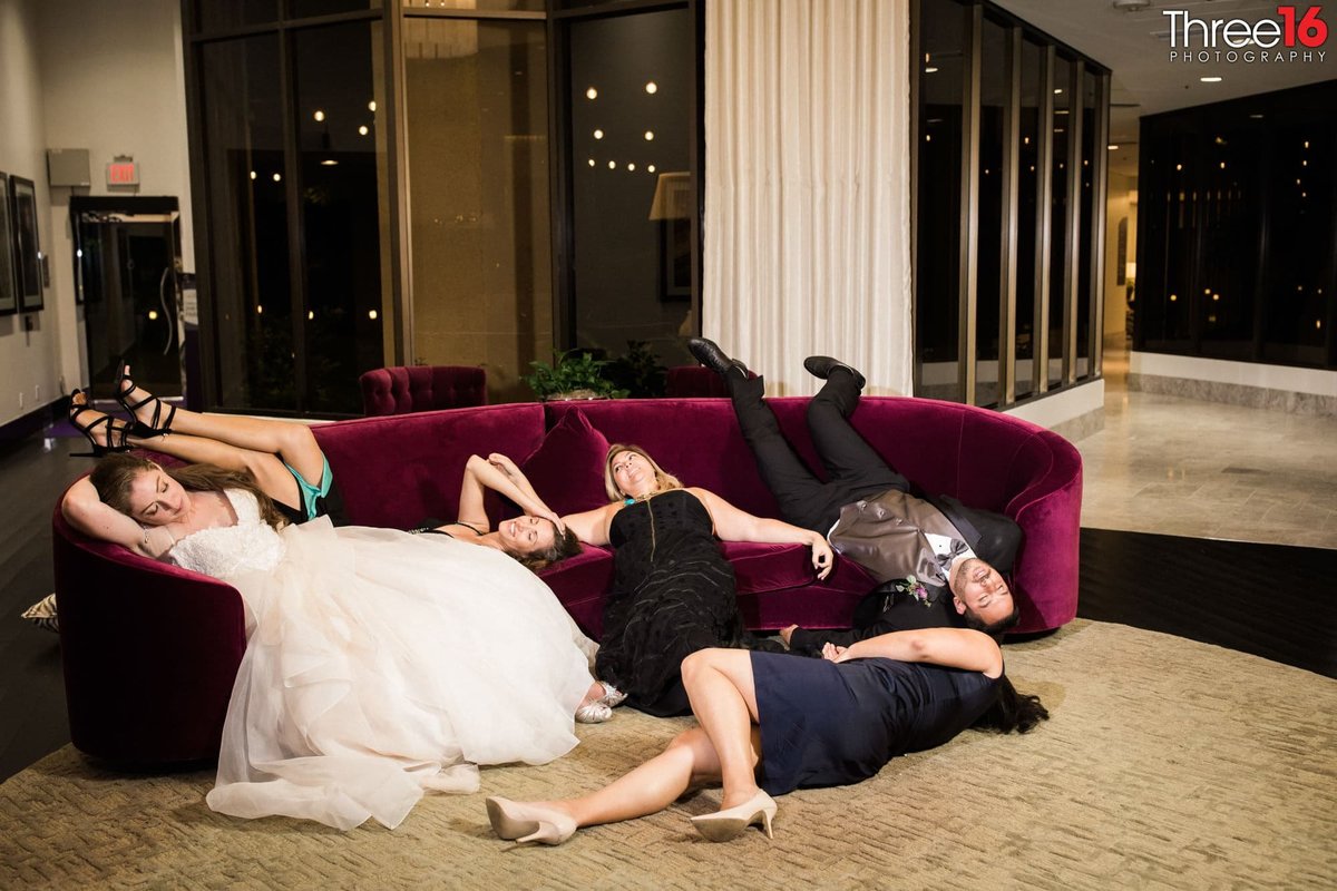Wedding Party laying on couches exhausted from the day
