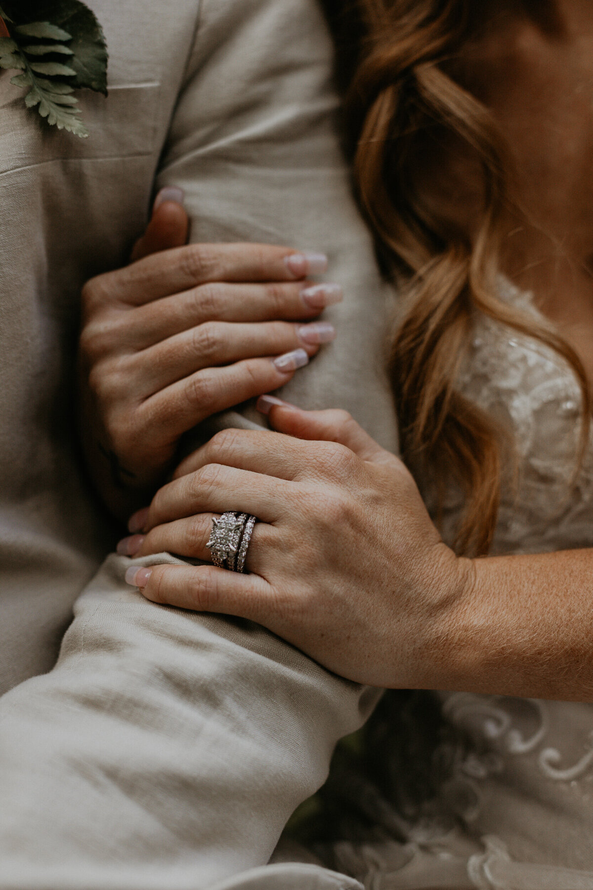 close up of a brides hands with  rings on