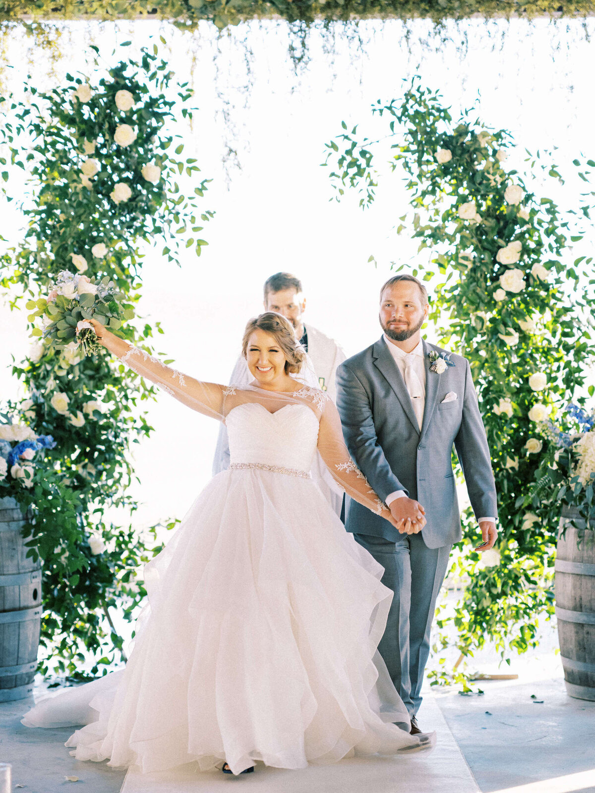 Newly married couple celebrates at the altar at spring wedding