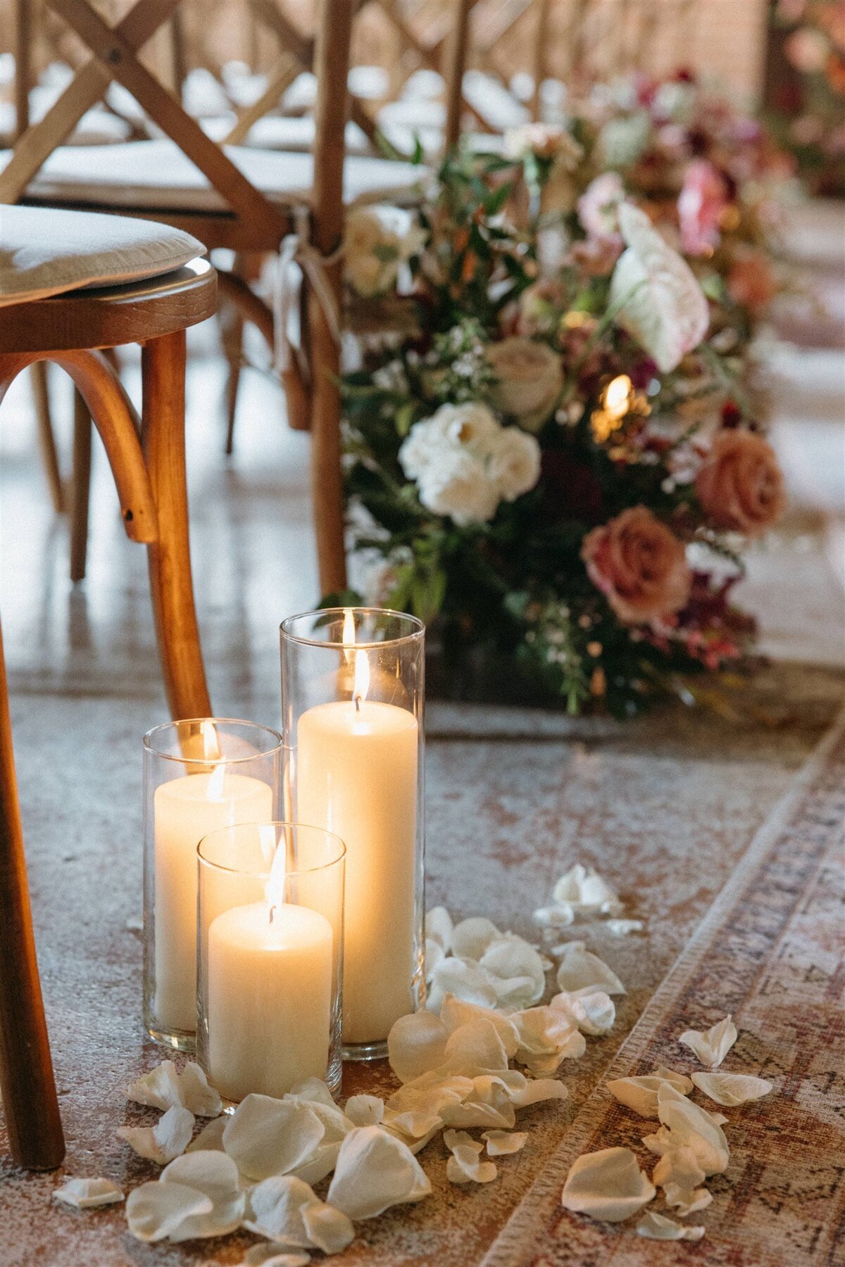 Candles and flower petals lining the aisle for spring wedding at the St Vrain, colorado wedding venue