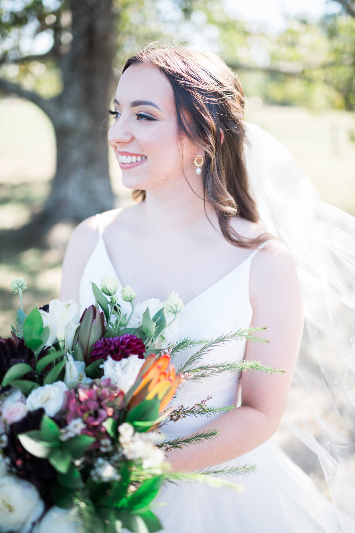 bridal photo of woman with beautiful dark and green bouquet