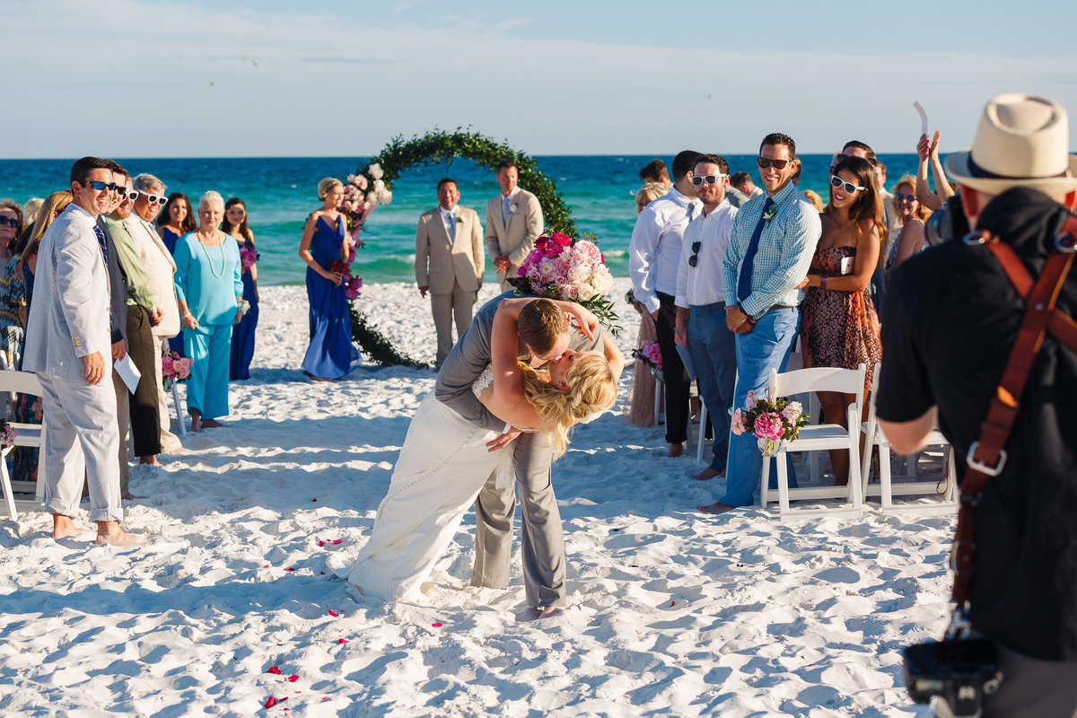 Henderson Resort wedding bride and groom kiss after their Destin beach wedding ceremony.