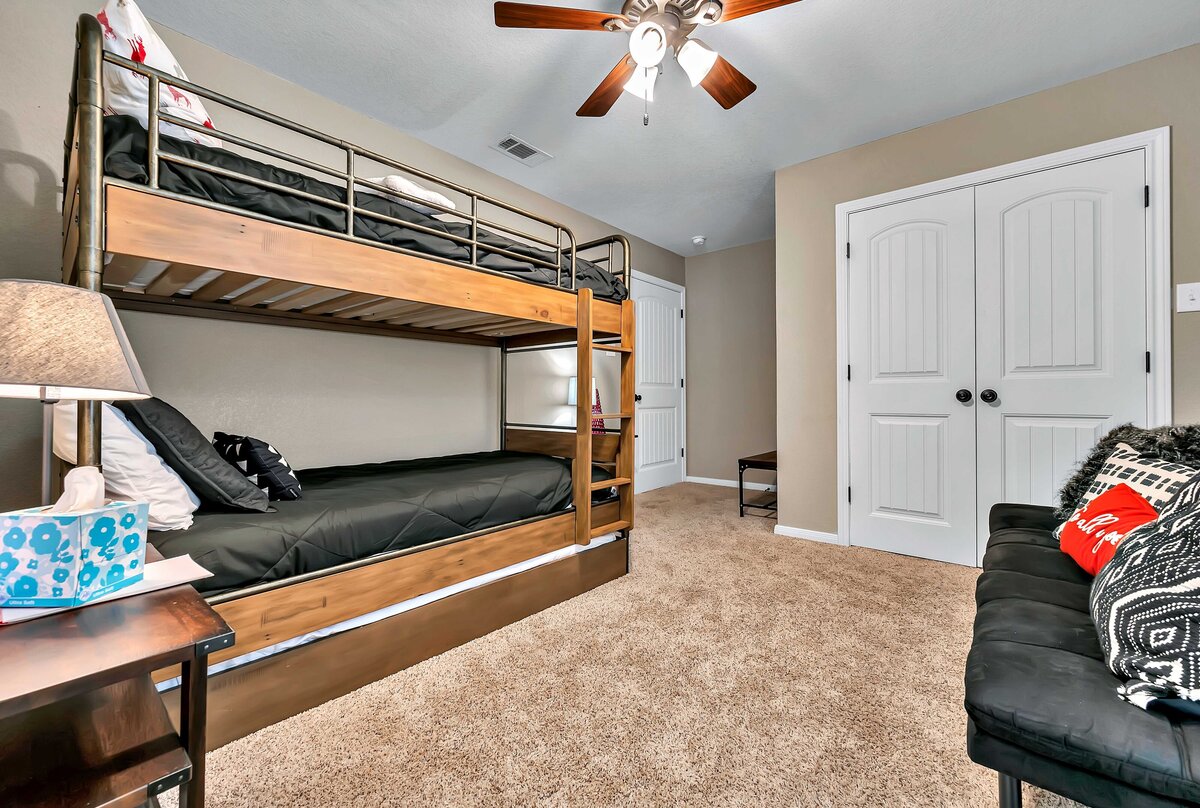 Bedroom with bunk beds for two in this four-bedroom, four-bathroom vacation rental home and guest house with free WiFi, fully equipped kitchen, firepit and room for 10 in Waco, TX.