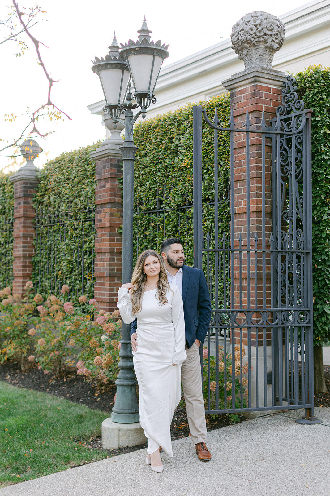 Couple embracing during golden hour engagement session in a Pittsburgh park