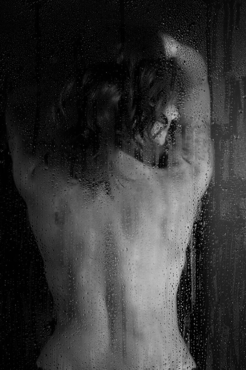 black and white photo of a woman in a shower