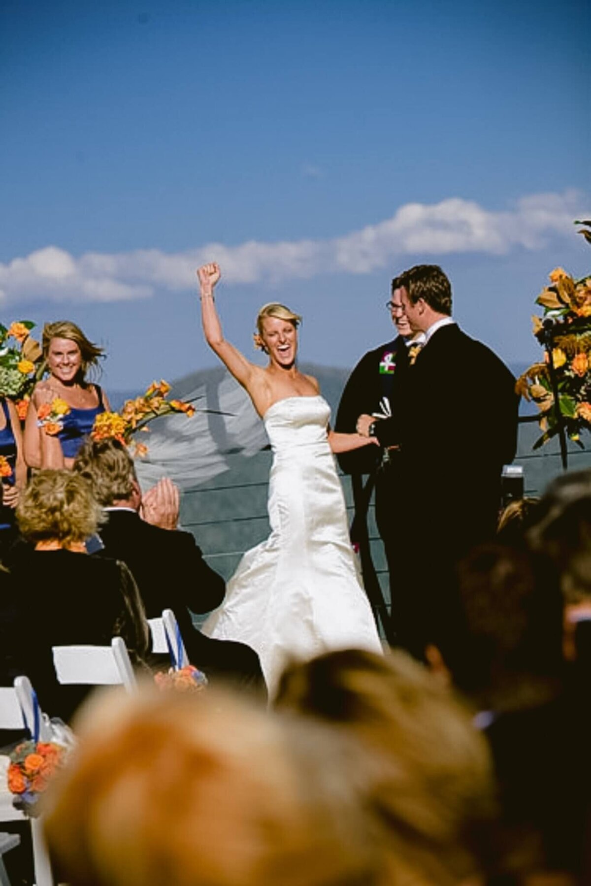 Bride cheering hand up during ceremony at High Camp Palisades Tahoe wedding