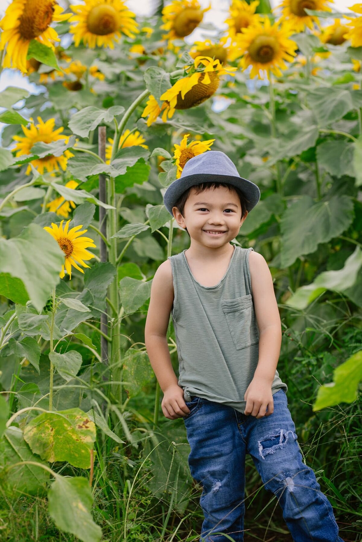 boy smiles during sunflower photoshoot