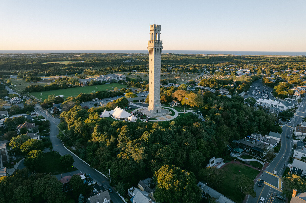 Aerial view of a tented wedding at Pilgrim Monument in Provincetown