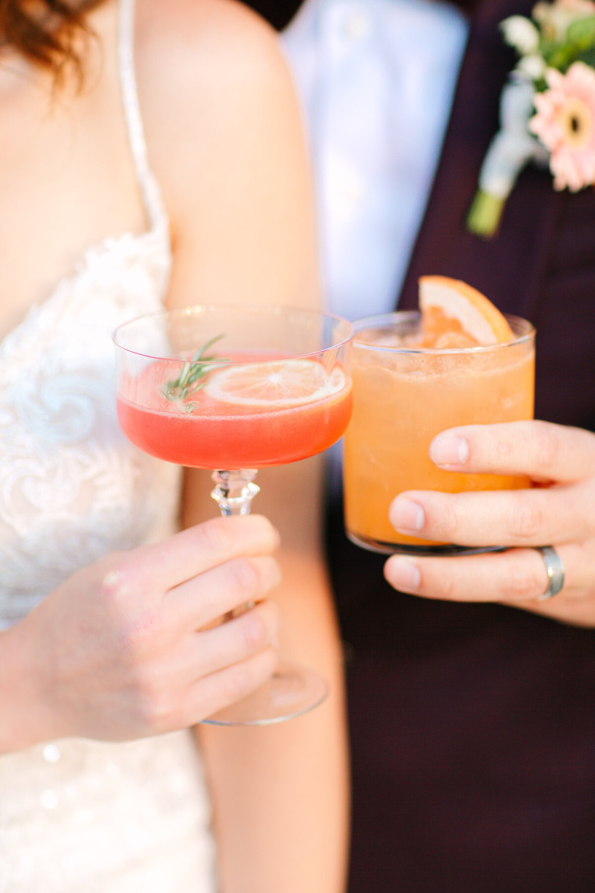 close up image of bride and groom cheersing festive signature cocktails at cocktail hour after napa wedding ceremony.