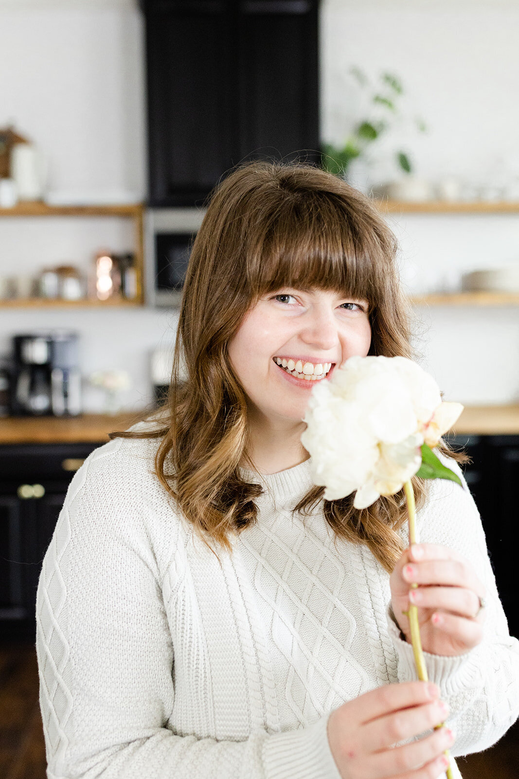 Hannah posing with a flower for branding photographer