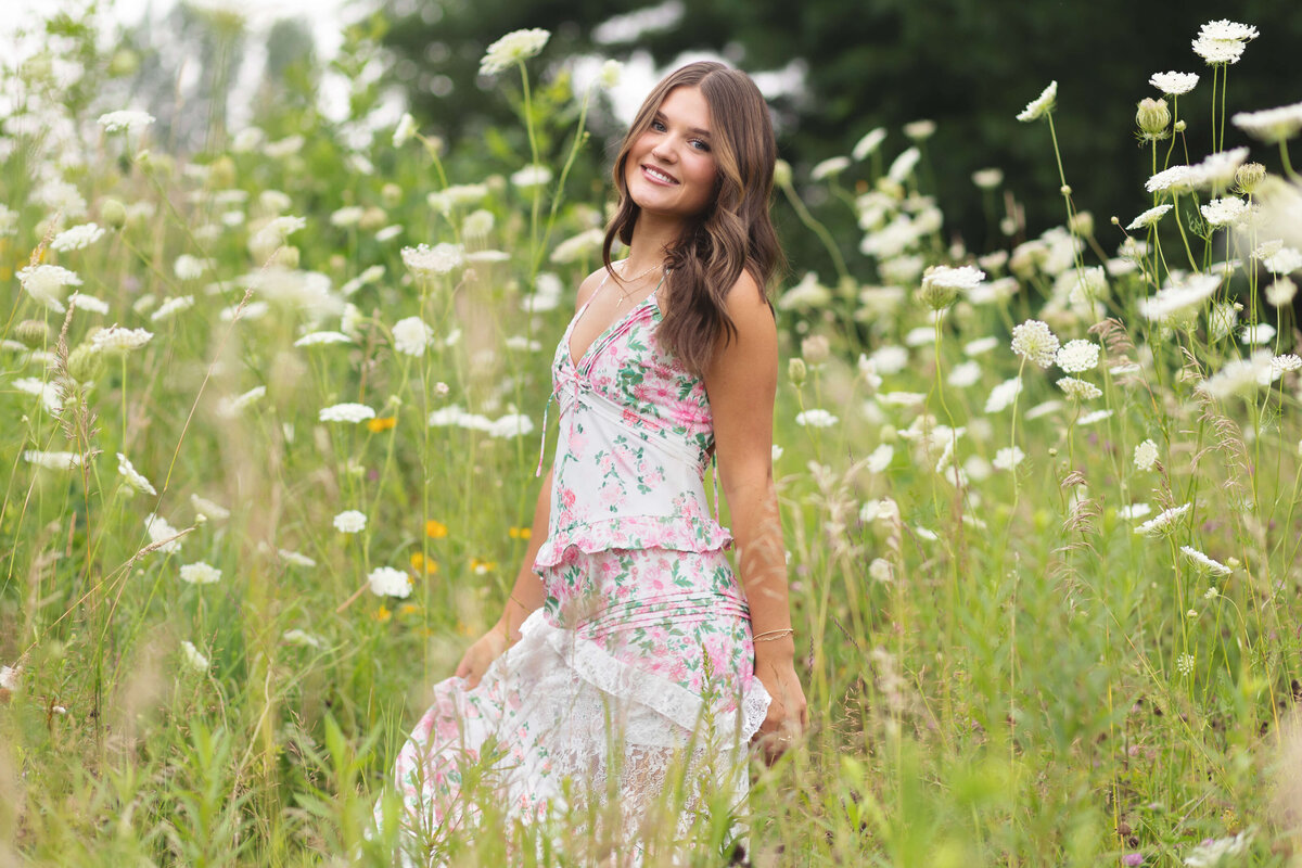 girl in long dress by white flowers