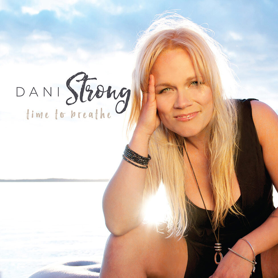 CD Cover Title Time To Breath Artist Dani Strong sitting inf ront of water elbow on her knee head in her hand sunlight streaming between side of her body and arm