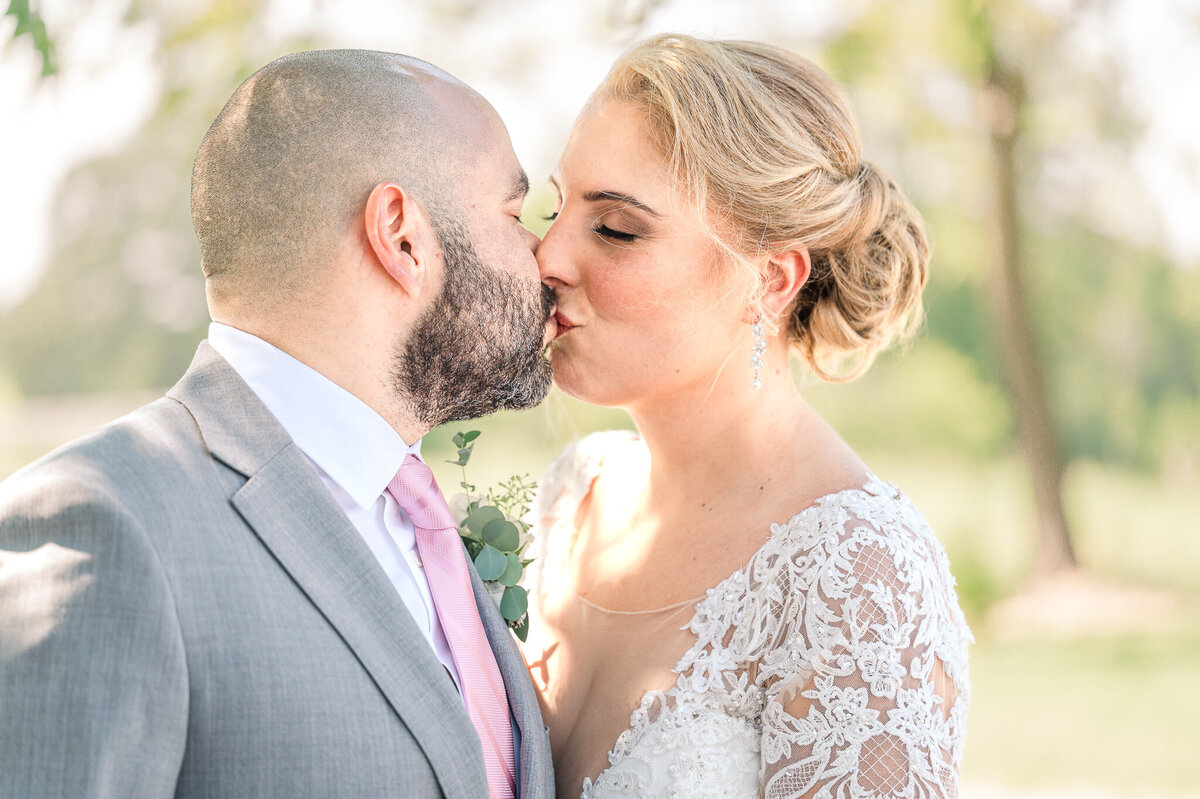 A couple kissing after their wedding ceremony in Raleigh enjoying their North Carolina wedding photography