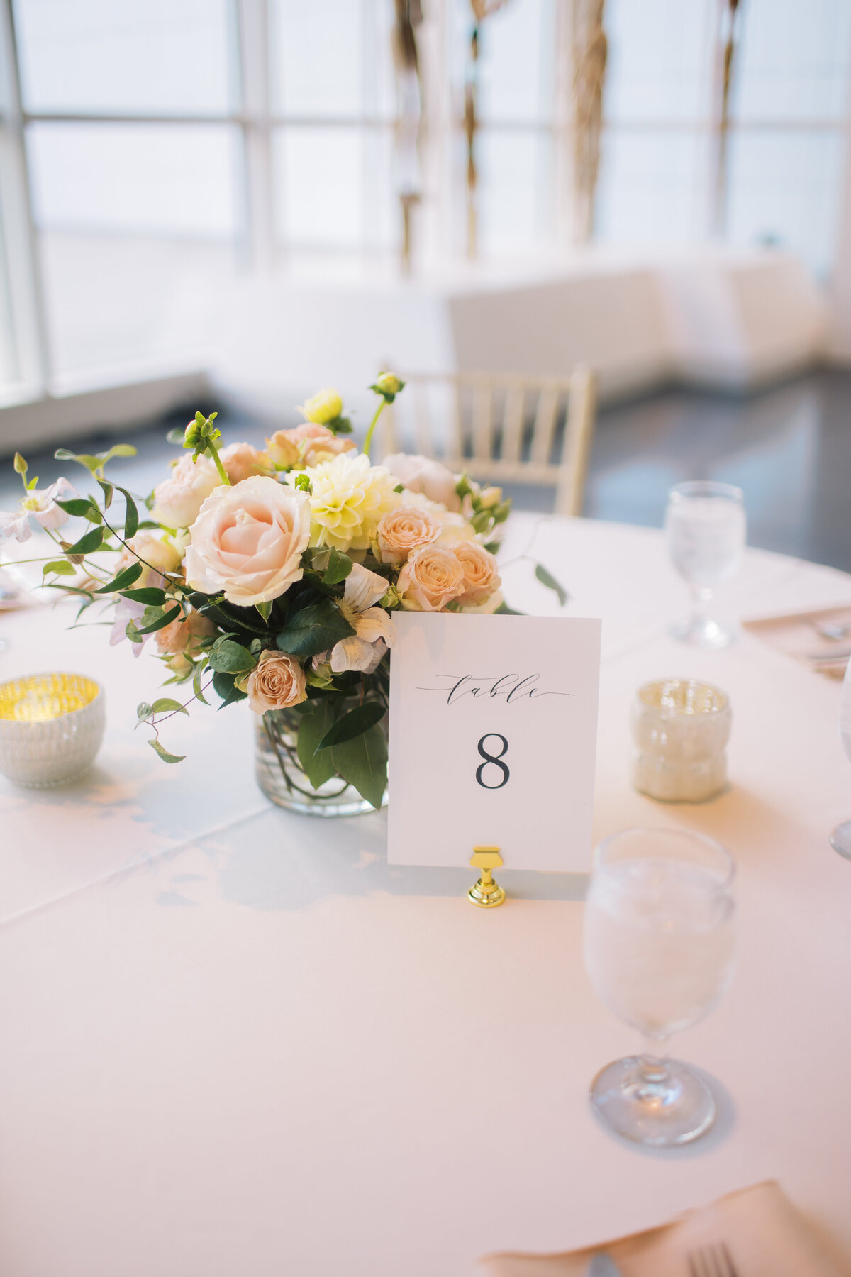 table with flowers, glassware and table number