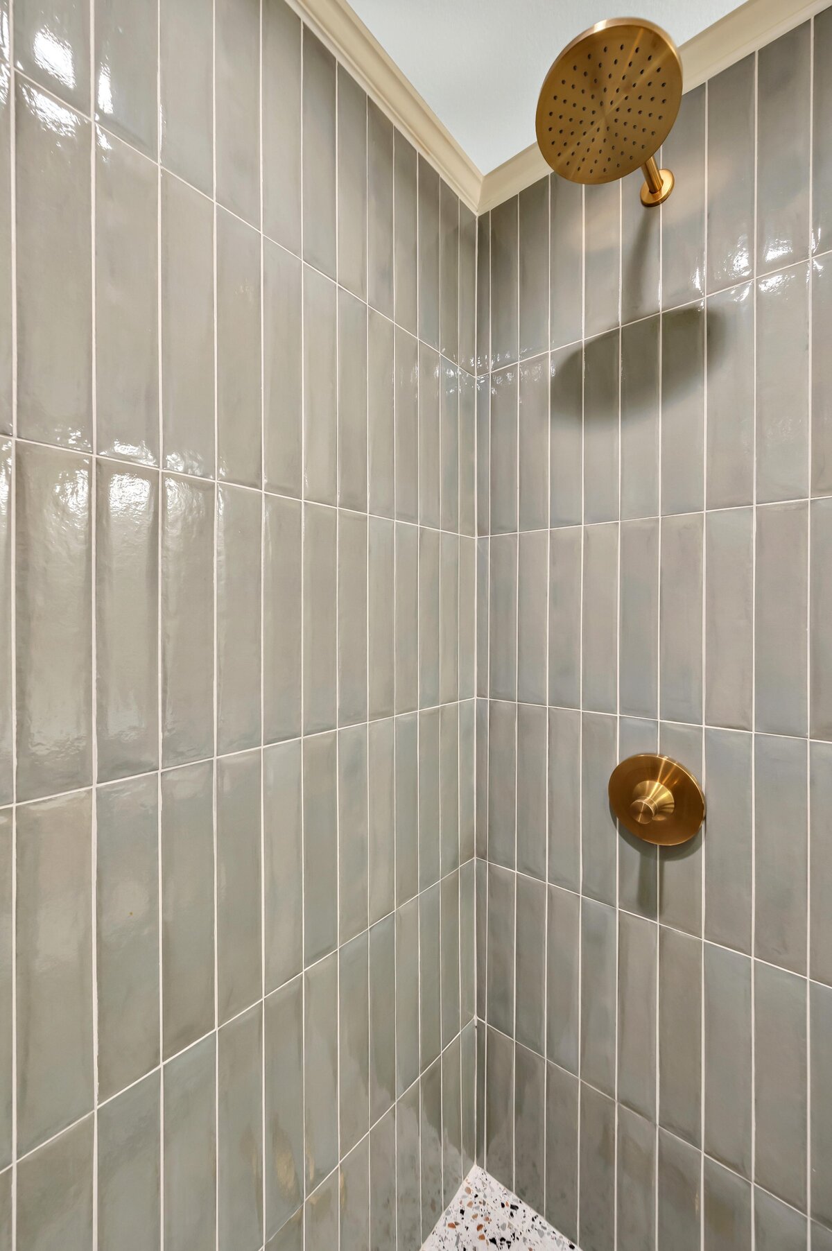 Beautiful tiled shower in the bathroom of this three-bedroom, three-bathroom vacation rental home with free wifi, outdoor theater, hot tub, propane grill and private yard in Waco, TX.