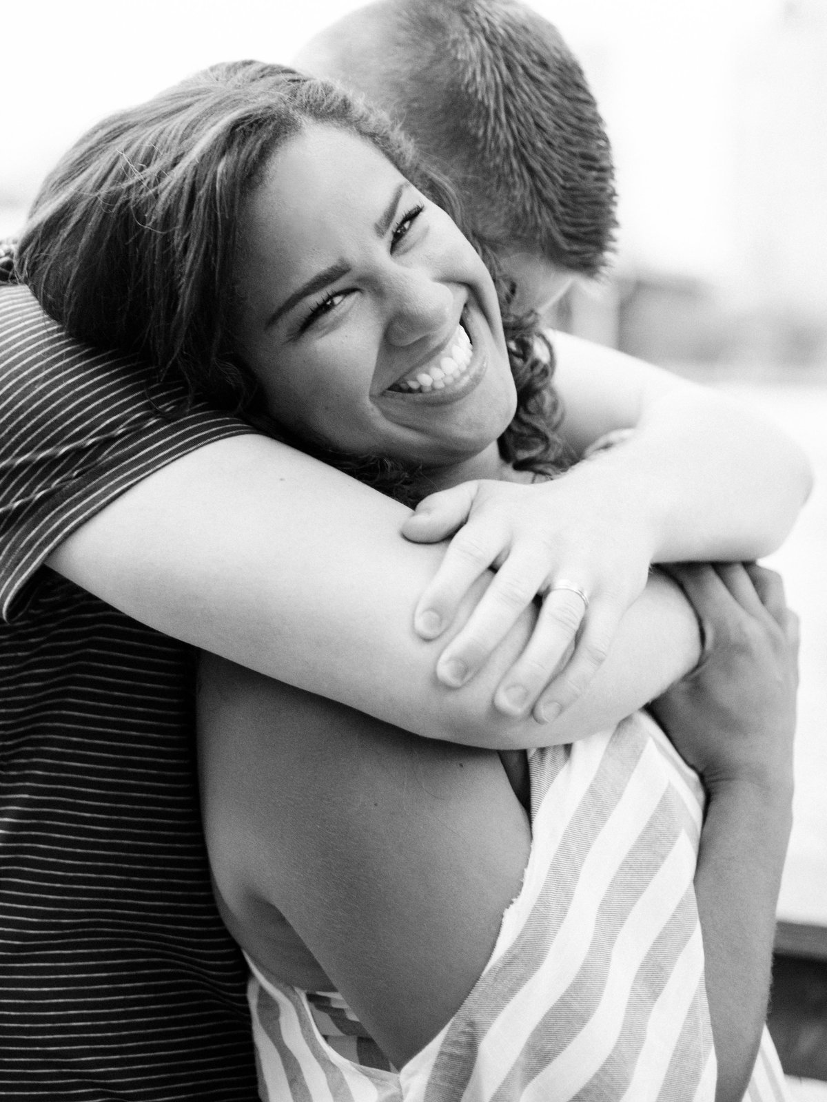fiance hugs over shoulders of girl in minneapolis summer engagement session