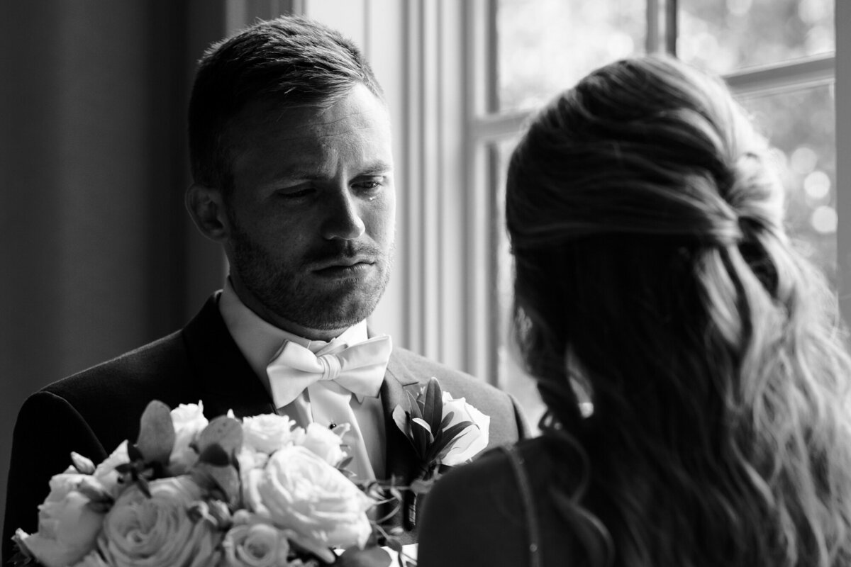 Groom sheds tears as his bride reads her vows to him privately before the ceremony