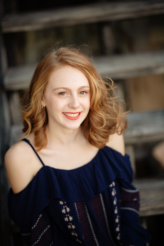 Senior session of young woman wearing a navy blue top