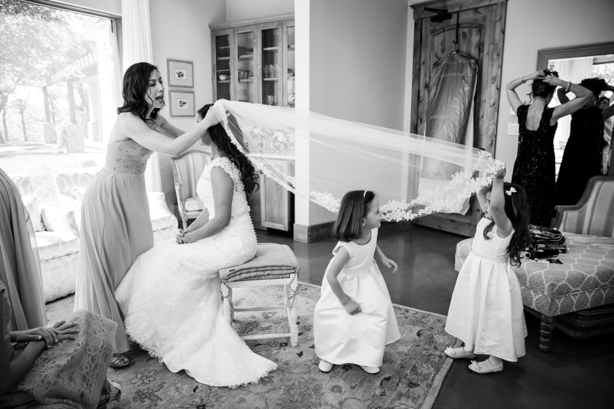 austin wedding photographer canyonwood ridge wedding photographer bride flowergirls playing with veil