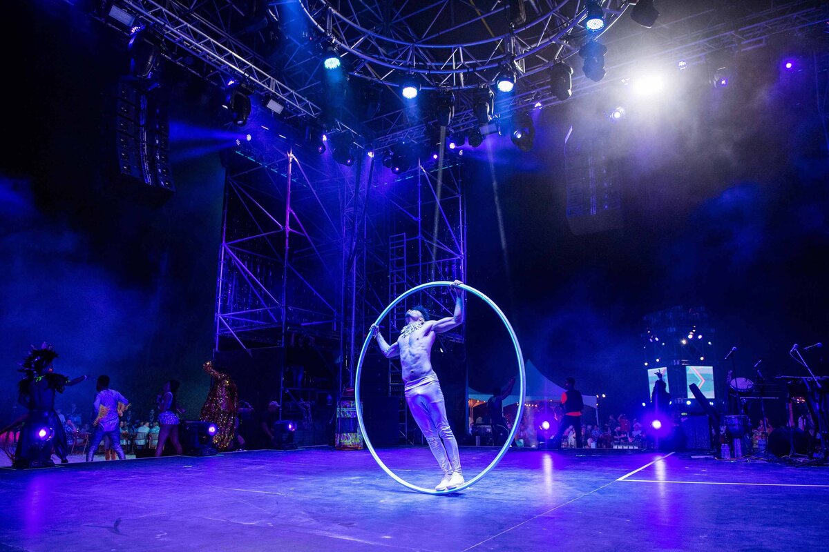 Dancer inside large metal ring on stage