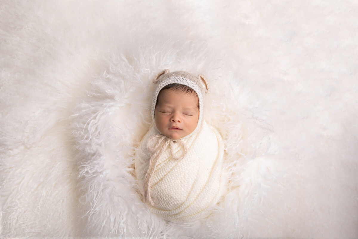 newborn photoshoot with baby  in white fur