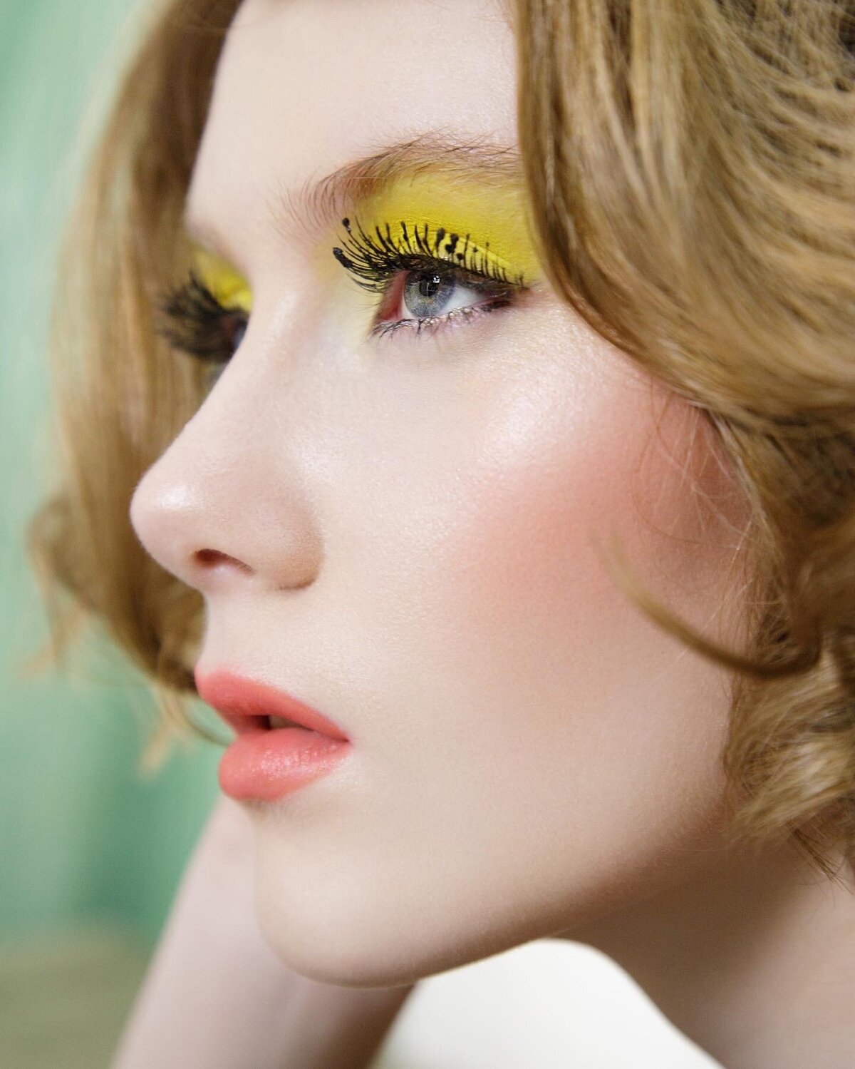 editorial-shoot-woman-wearing-yellow-eye-makeup-peach-lips