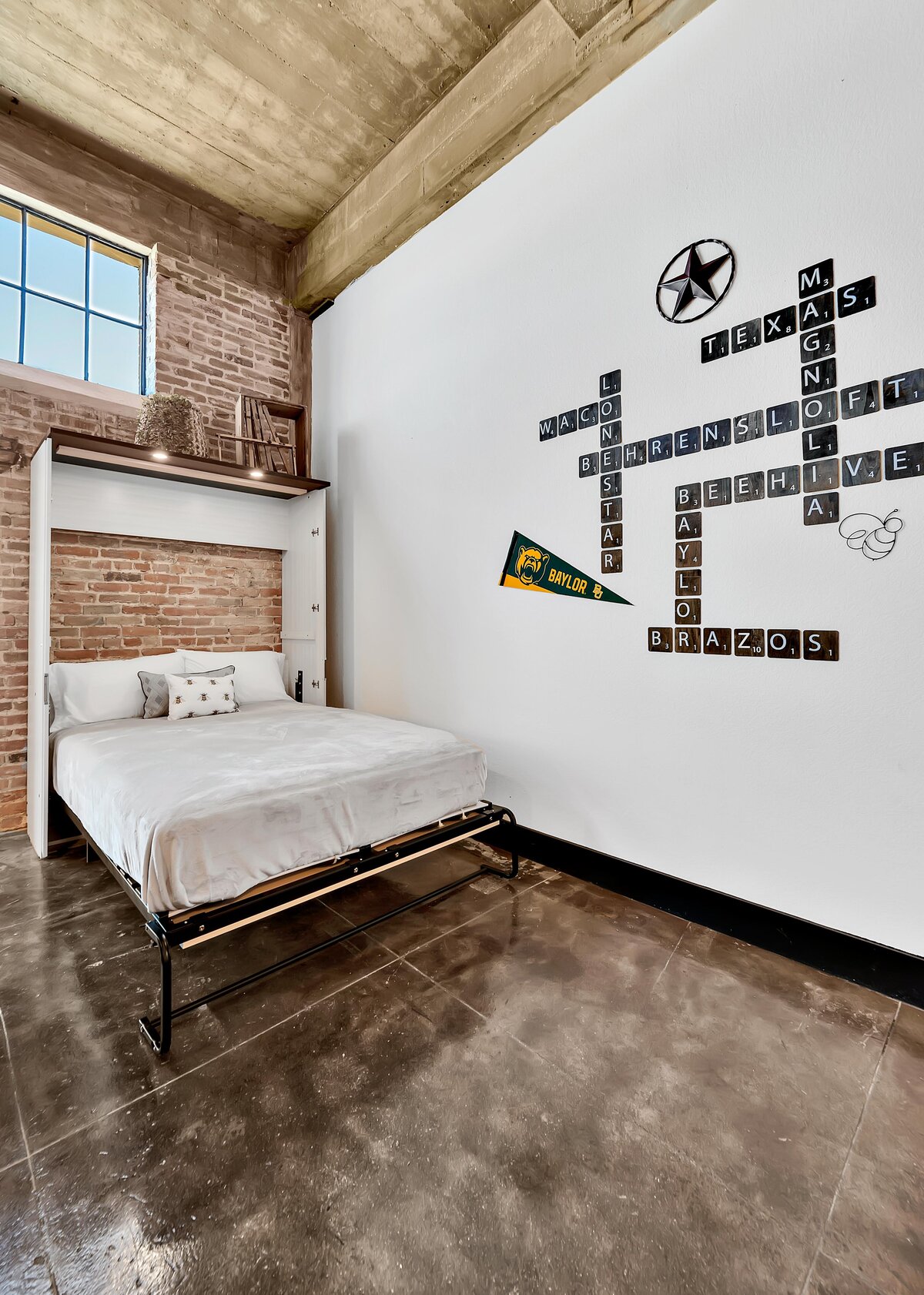 Hidden Murphy bed for two in this one-bedroom, one-bathroom vintage condo that sleeps 4 in the historic Behrens building in the heart of the Magnolia Silo District in downtown Waco, TX.