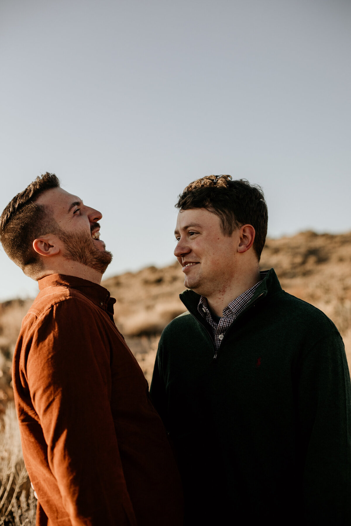 gay couple standing close and laughing