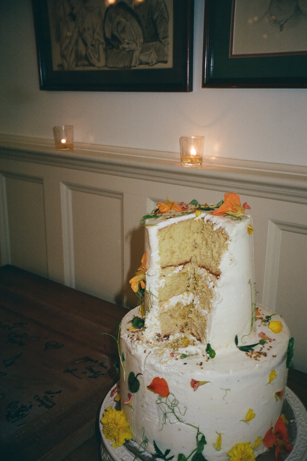 Film image of a wedding cake that has been cut at the Atlantic Inn