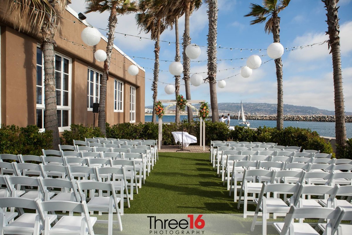 Outdoor wedding ceremony setup under the palm trees of the Portofino Hotel