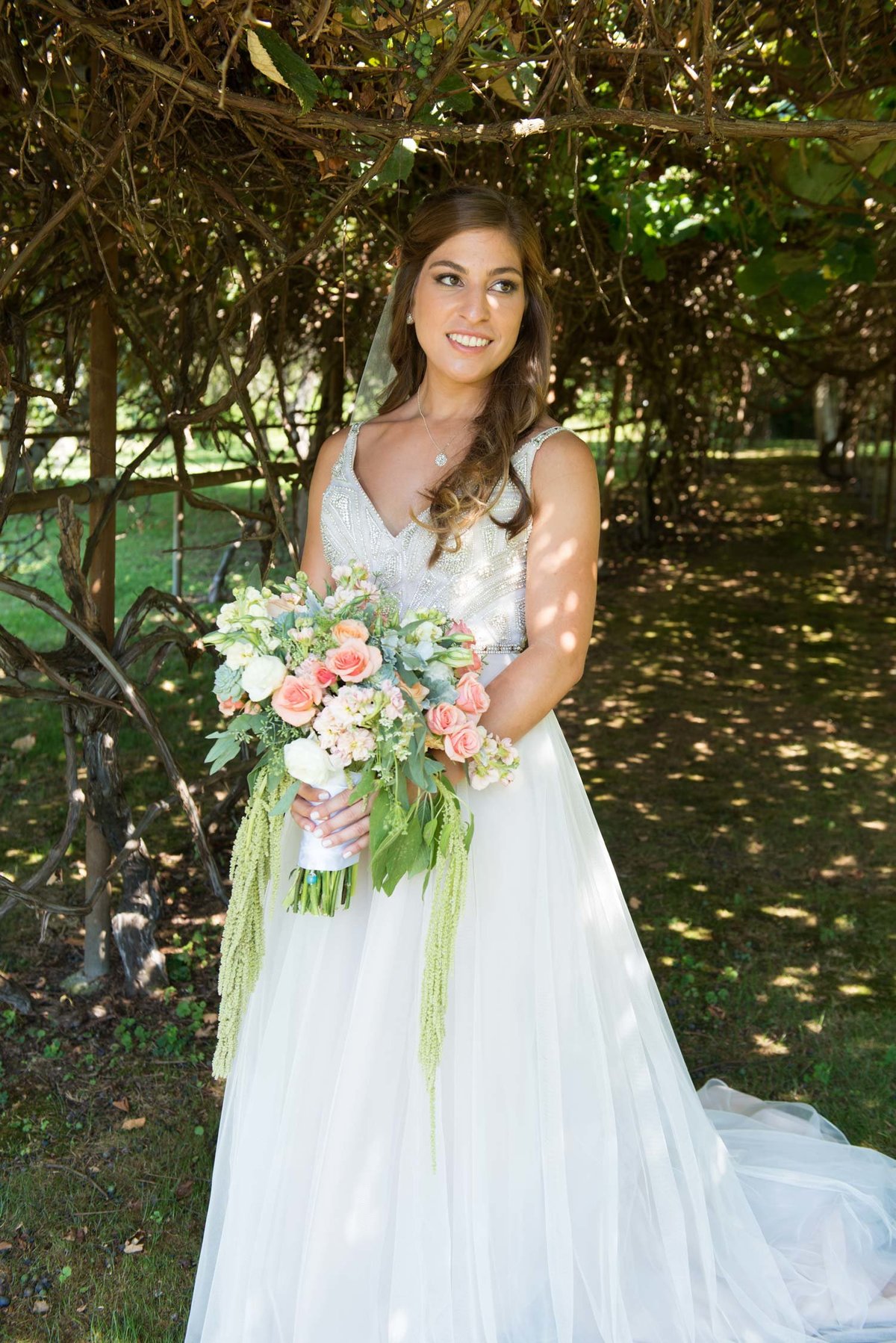Bride outside holding bouquet at Flowerfield