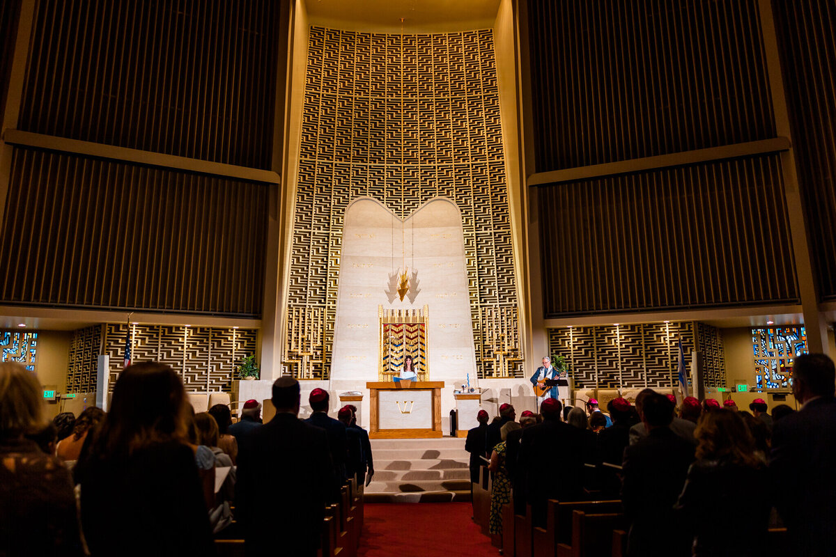 A view from the center aisle of a temple during a bat mitzvah speech