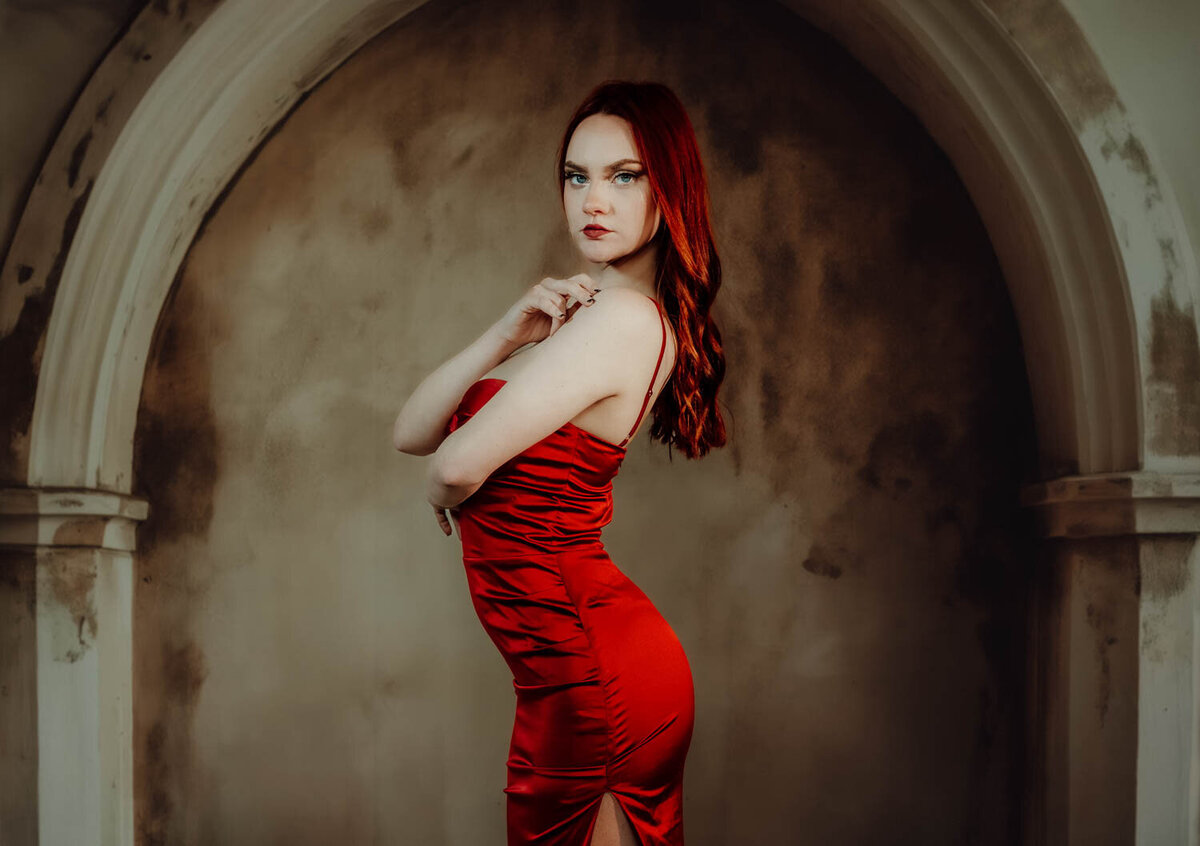 High school senior girl in Lansing, Michigan posing in downtown urban setting with off-camera flash lighting.

