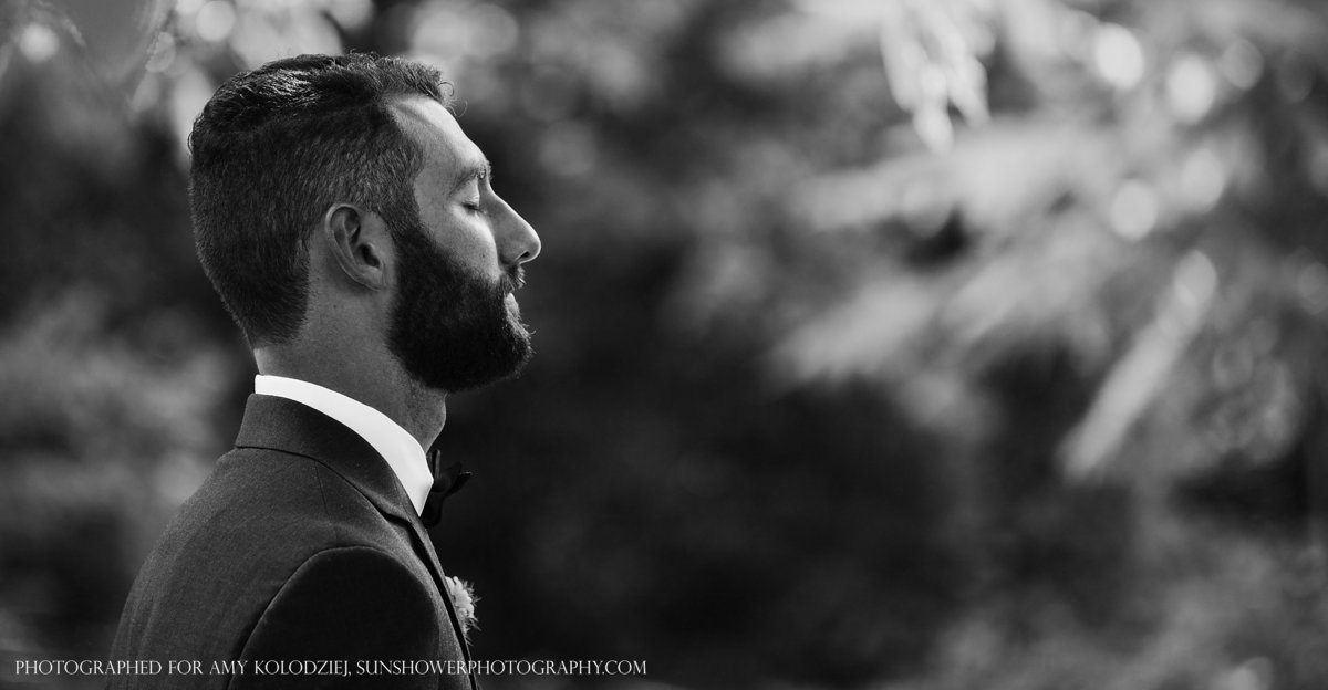 charlotte wedding photographer jamie lucido captures the groom's quiet reflection as he awaits his bride during their first look