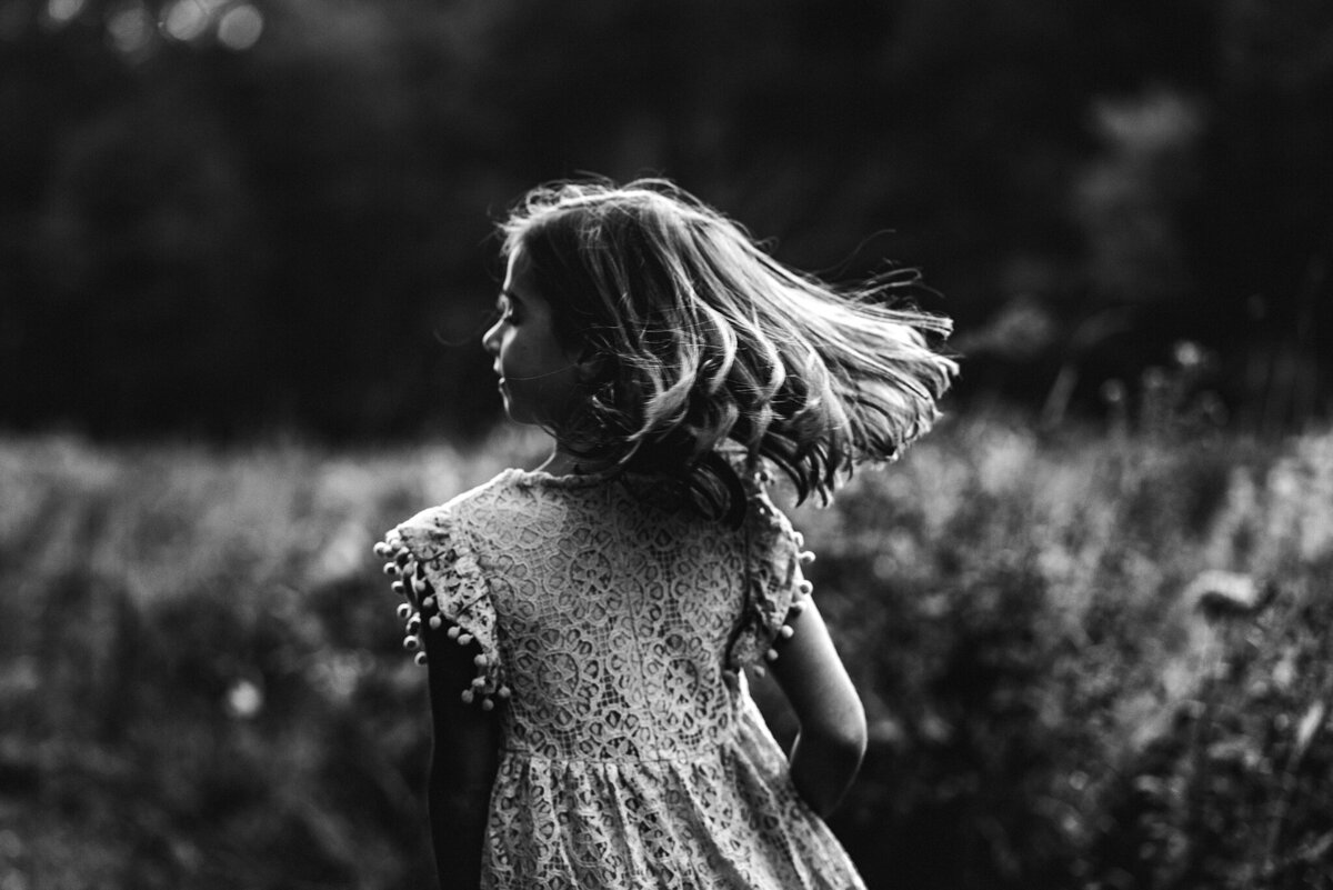girl running in field black and white