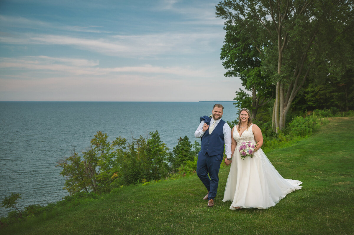 Bride and Groom walking by Lake Erie at Lakeshore Country Club.