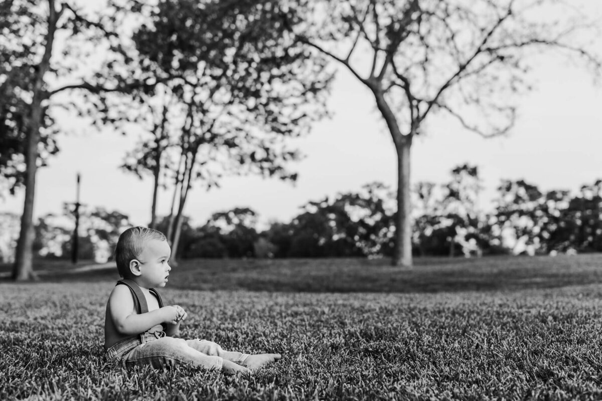 black and white photo of oaklee sitting at park
