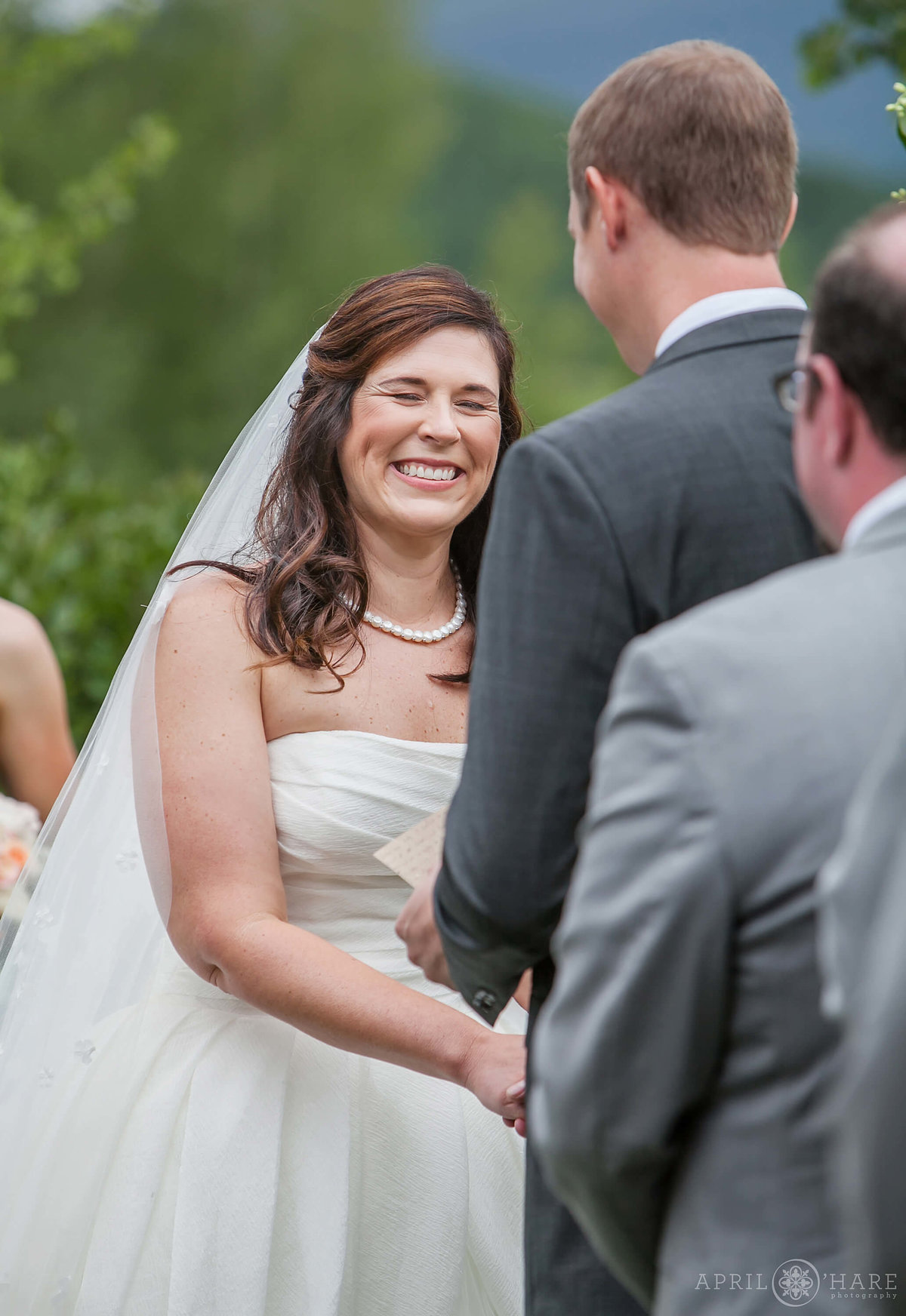 Sweet wedding photo of bride laughing at her outdoor Colorado wedding at Mountain wedding garden Crested Butte