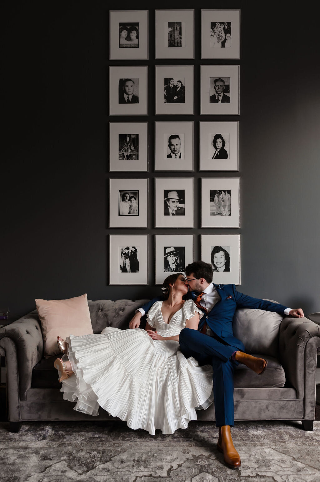 Bride and groom kiss on a couch at The Mea District in Chicago, IL