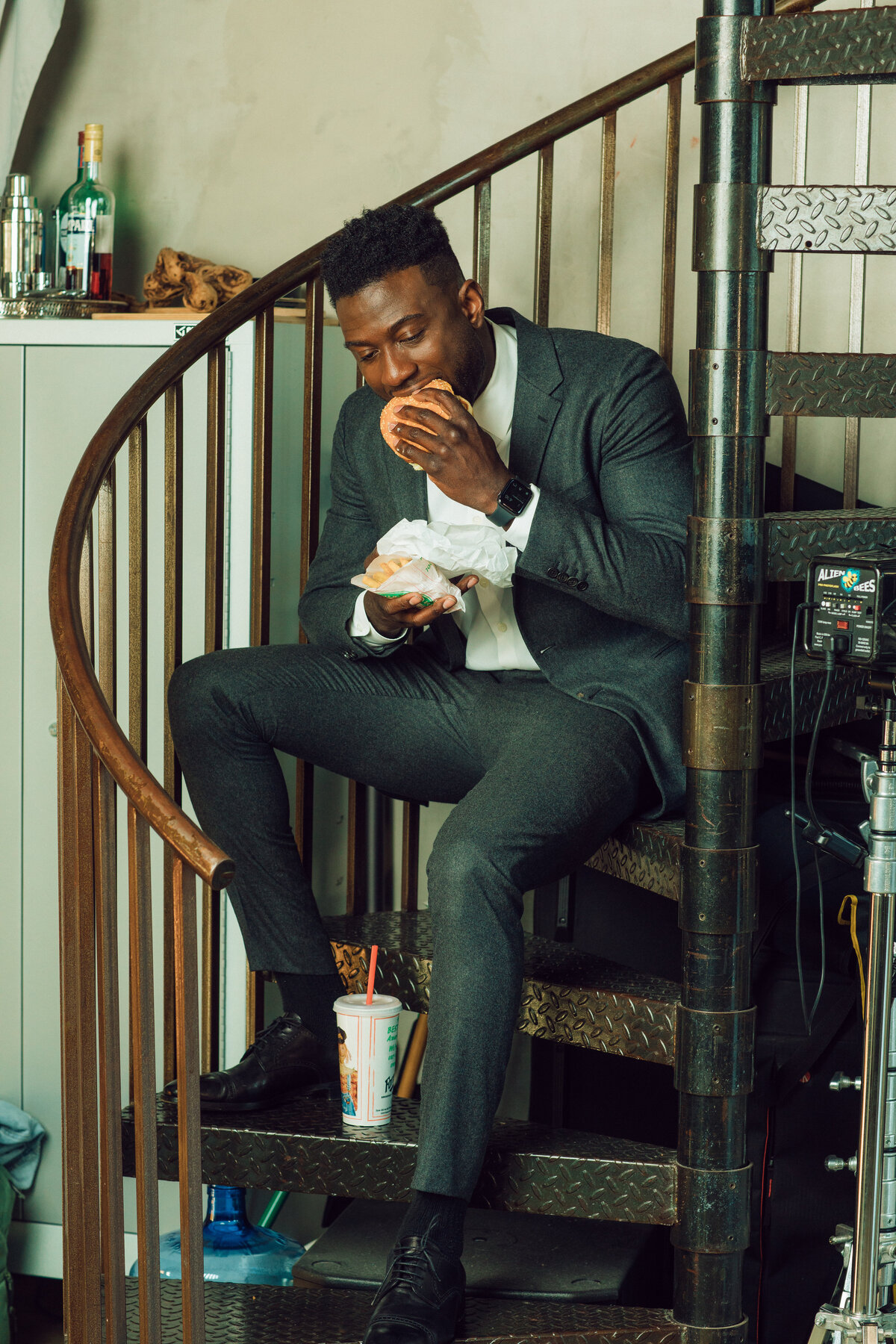 Portrait Photo Of Young Black Man In Suit Eating Hamburger Los Angeles