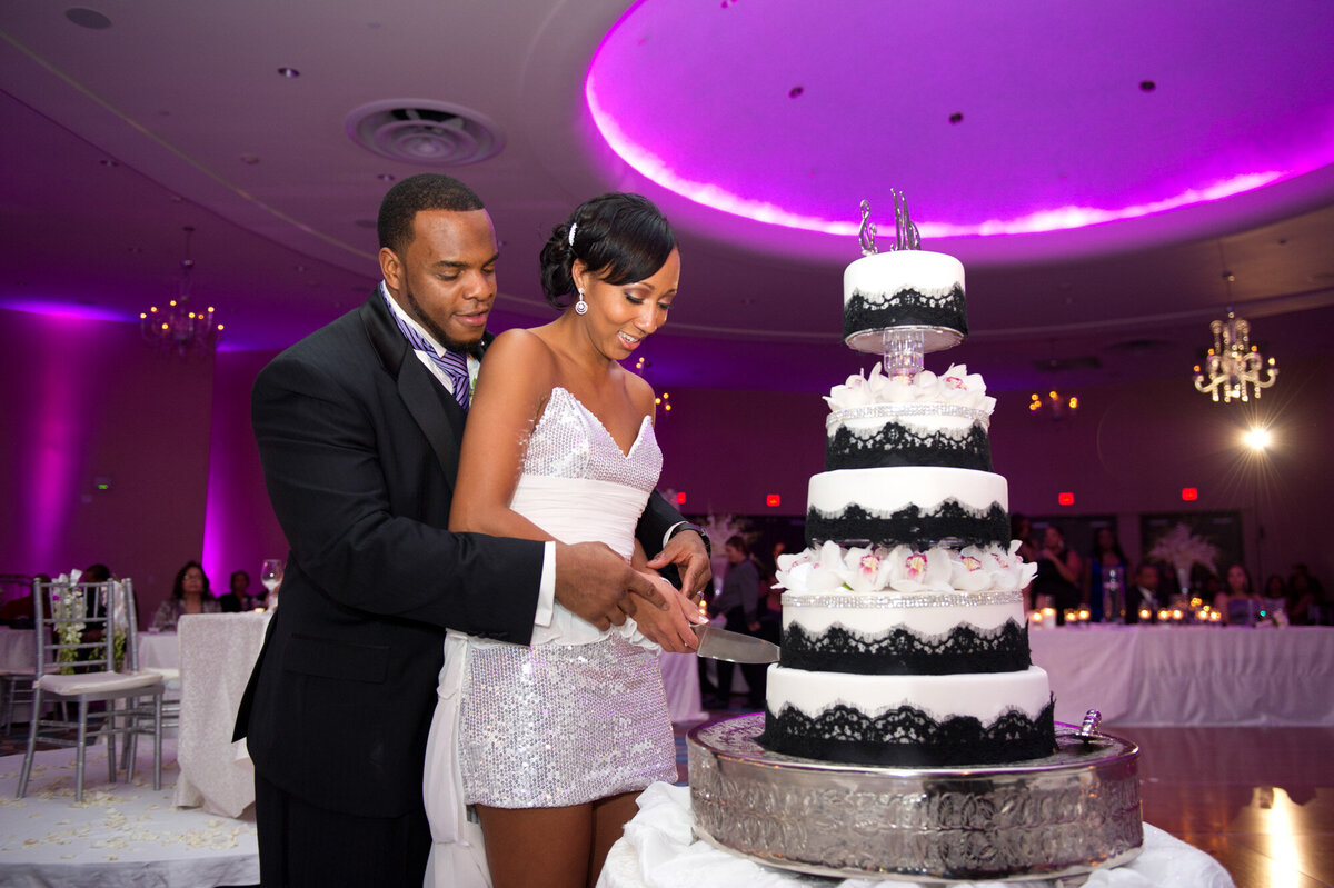 Bride and groom cutting their elegant five tier cake