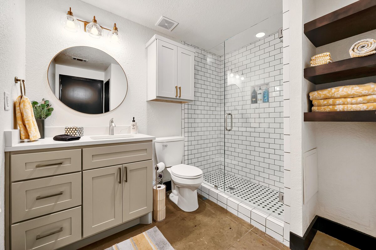 Bright and beautiful bathroom with walk-in shower in this one-bedroom, one-bathroom vintage condo that sleeps 4 in the historic Behrens building in the heart of the Magnolia Silo District in downtown Waco, TX.