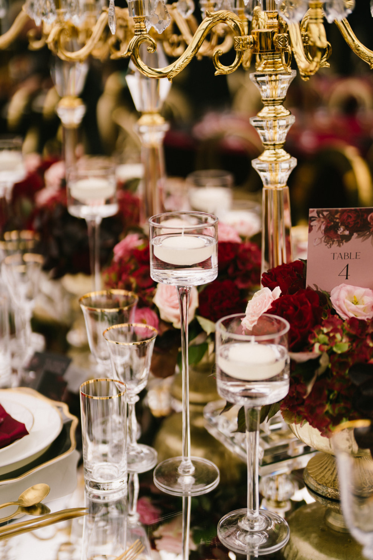 black-gold-burgundy-red-tent-reception-roses-candelabras-floating-candles
