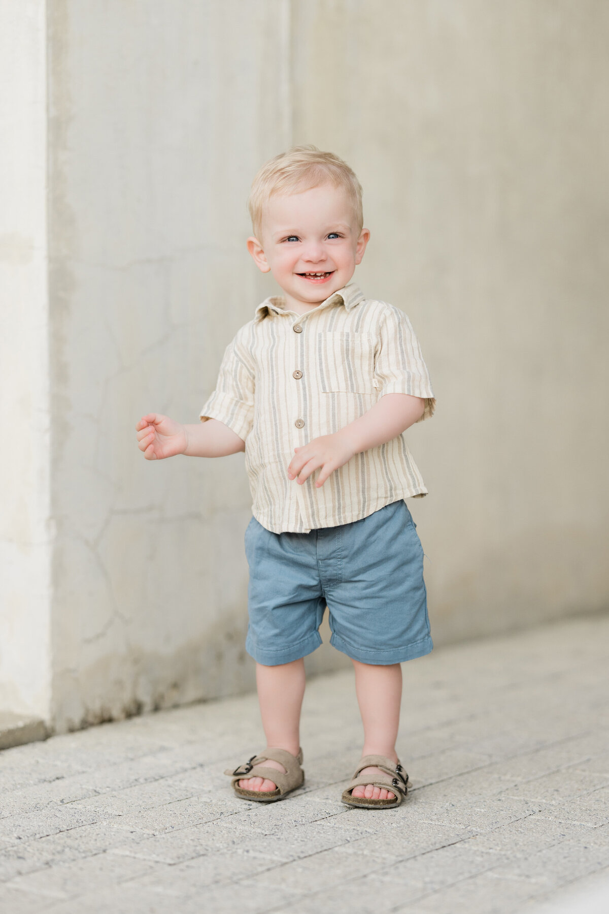 A small child standing and smiling.