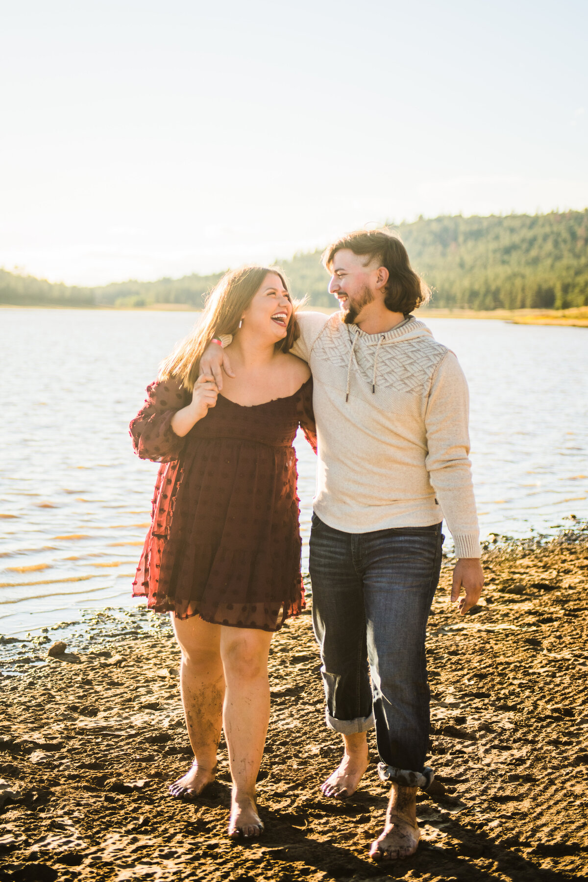 Couple walking along Lake Mary Flagstaff sunshine summer smiling engagement