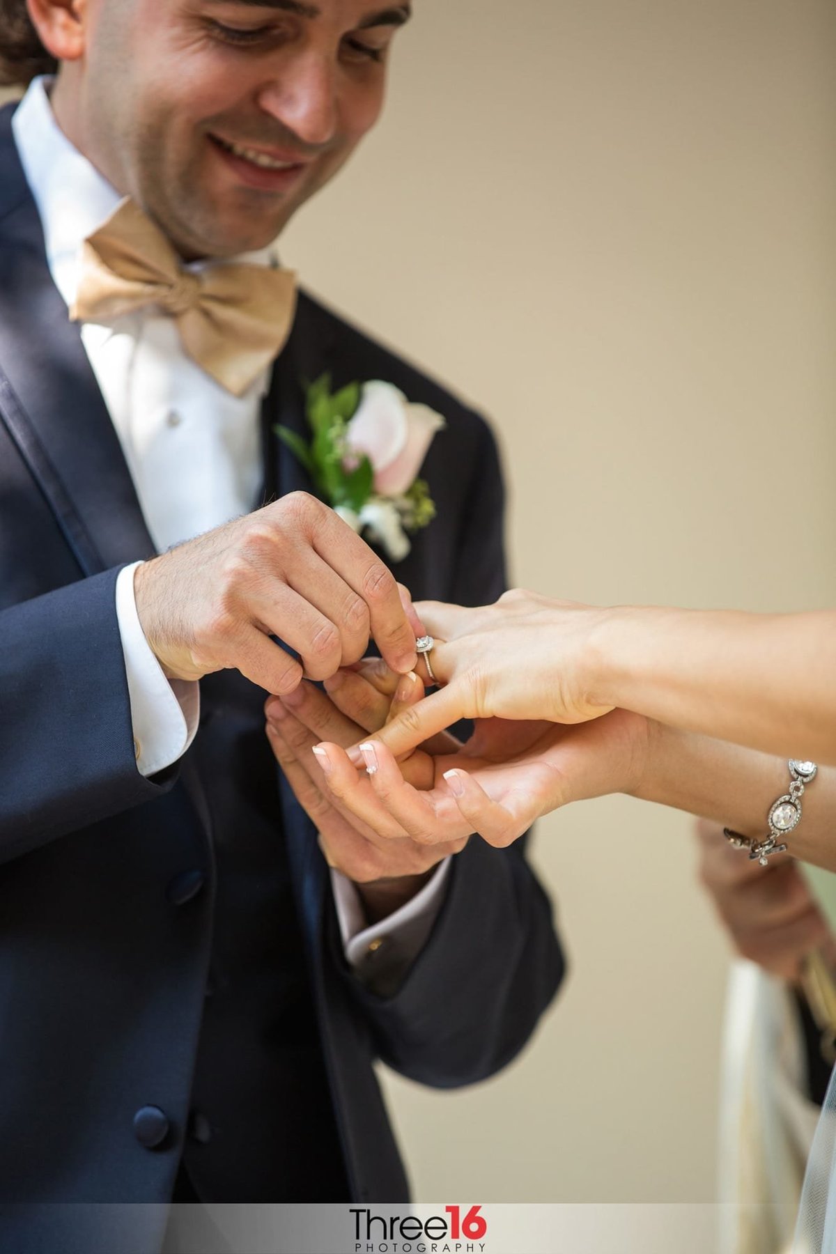 Groom places ring on Bride's finger