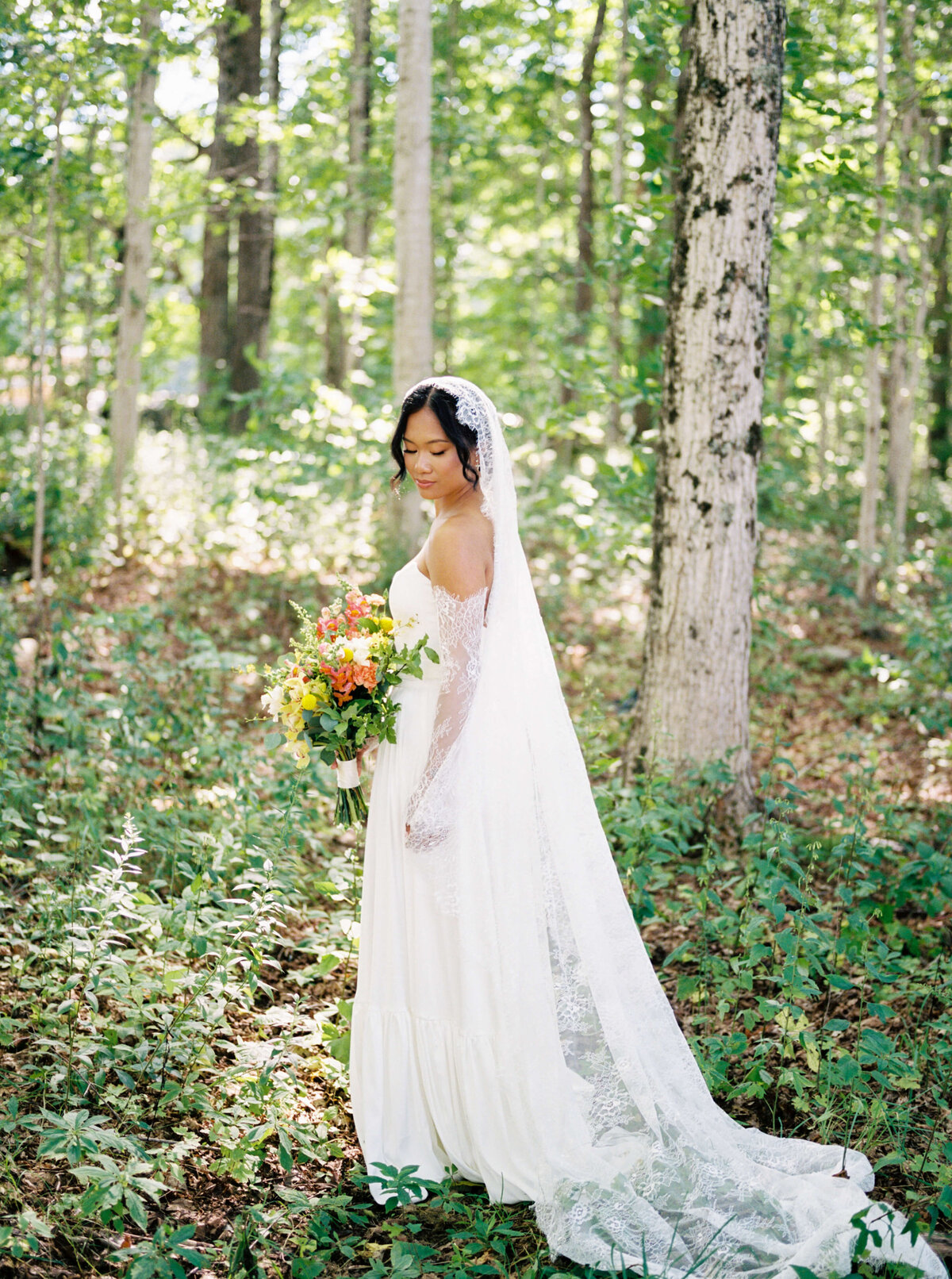 Bride in forest wearing  lace dress at  Woodburn Ridge Wedding, Nova Scotia