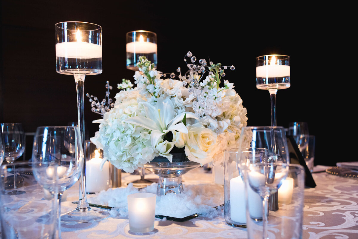 lighted candle and floral centerpieces