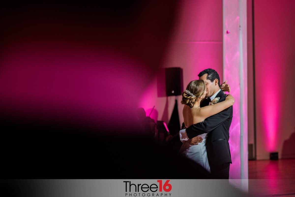 Bride and Groom share a romantic kiss during their first dance
