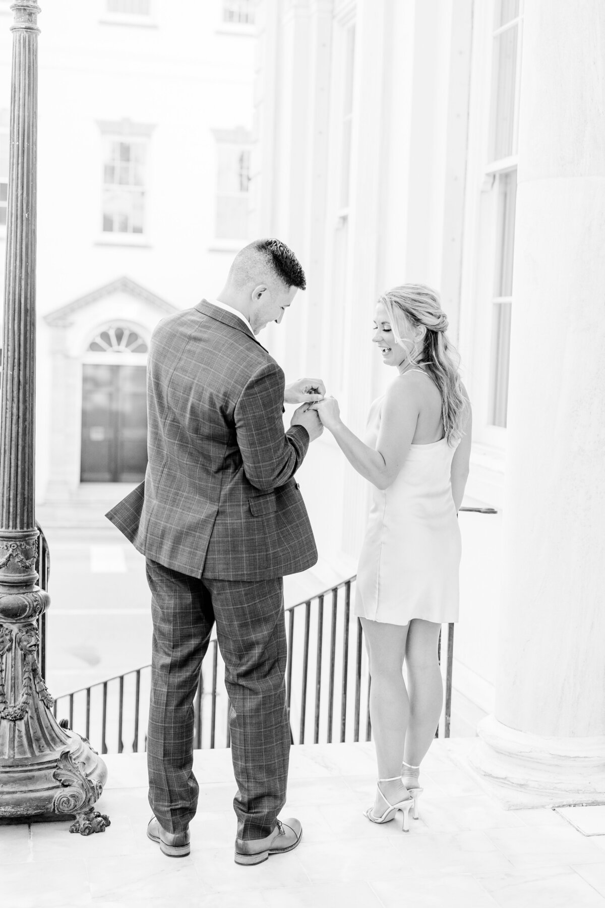 groom adjusting brides ring charleston engagement